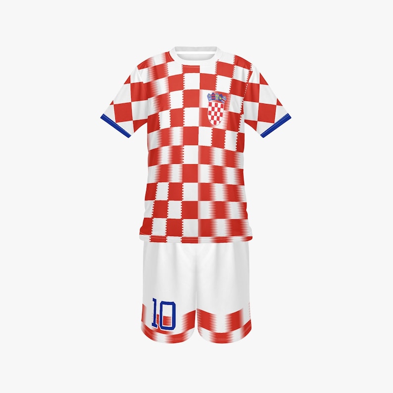 May include: A Croatia soccer uniform set, featuring a red and white checkered jersey with blue trim and a Croatian coat of arms emblem. The matching white shorts have the number 10 in blue. The kit is designed for sports.