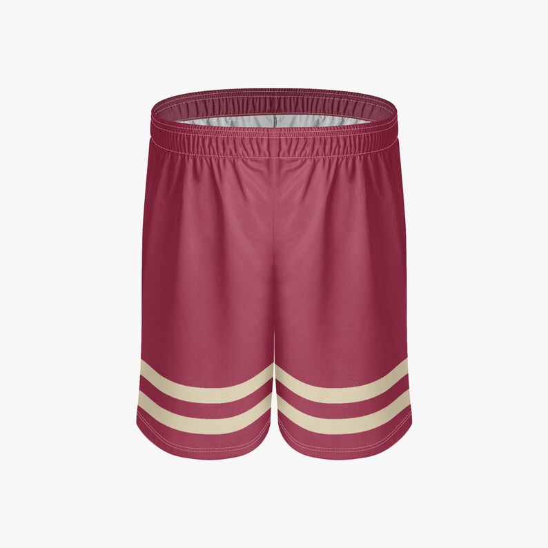 May include: Maroon athletic shorts with two cream stripes near the hem. The shorts feature an elasticated waistband and a relaxed fit, suitable for sports or casual wear.
