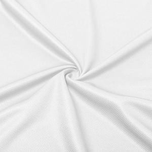 May include: Close-up of white fabric with a textured, dimpled surface. The fabric is gathered in a swirl, creating folds and shadows that highlight its texture and drape. The bright white color suggests a clean, crisp aesthetic.