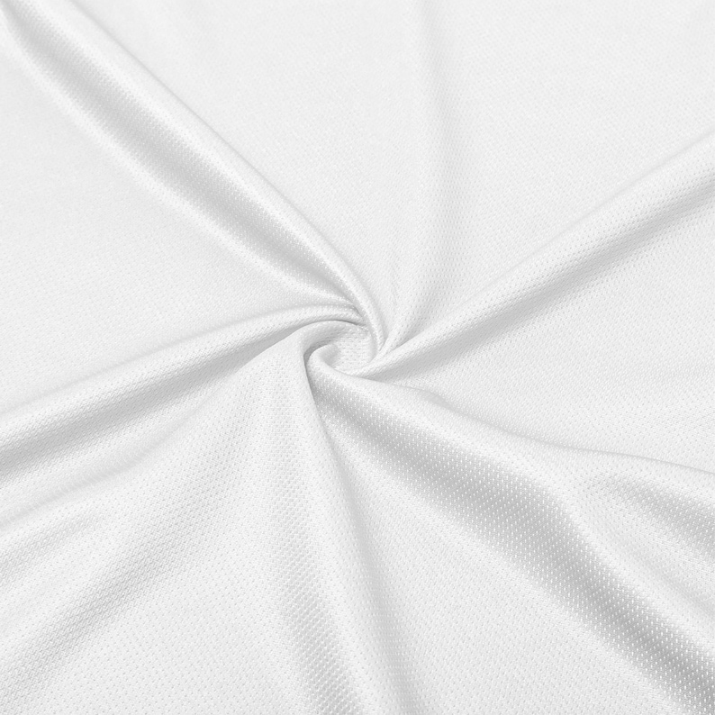 May include: Close-up of white fabric with a textured, dimpled surface. The fabric is gathered in a swirl, creating folds and shadows that highlight its texture and drape. The bright white color suggests a clean, crisp aesthetic.
