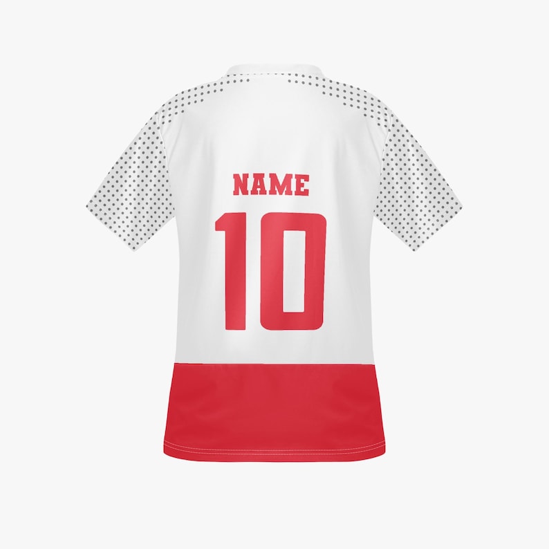 May include: White athletic jersey with red accents. The back features the word "NAME" above the number "10" in red. The sleeves have a dotted pattern. The bottom of the jersey is red.
