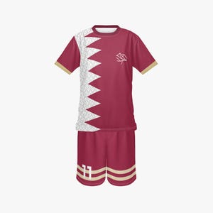 May include: Maroon football kit with white and gold detailing. The jersey has a white zig-zag pattern on the left and a small white emblem on the right. The shorts display the number 11 in white.