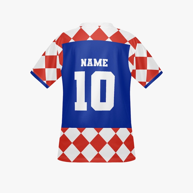 May include: A white and red checkered soccer jersey with a blue panel on the back. The jersey features the number 10 in white and the word "NAME" above it. The sleeves and lower portion of the jersey have a red and white diamond pattern.