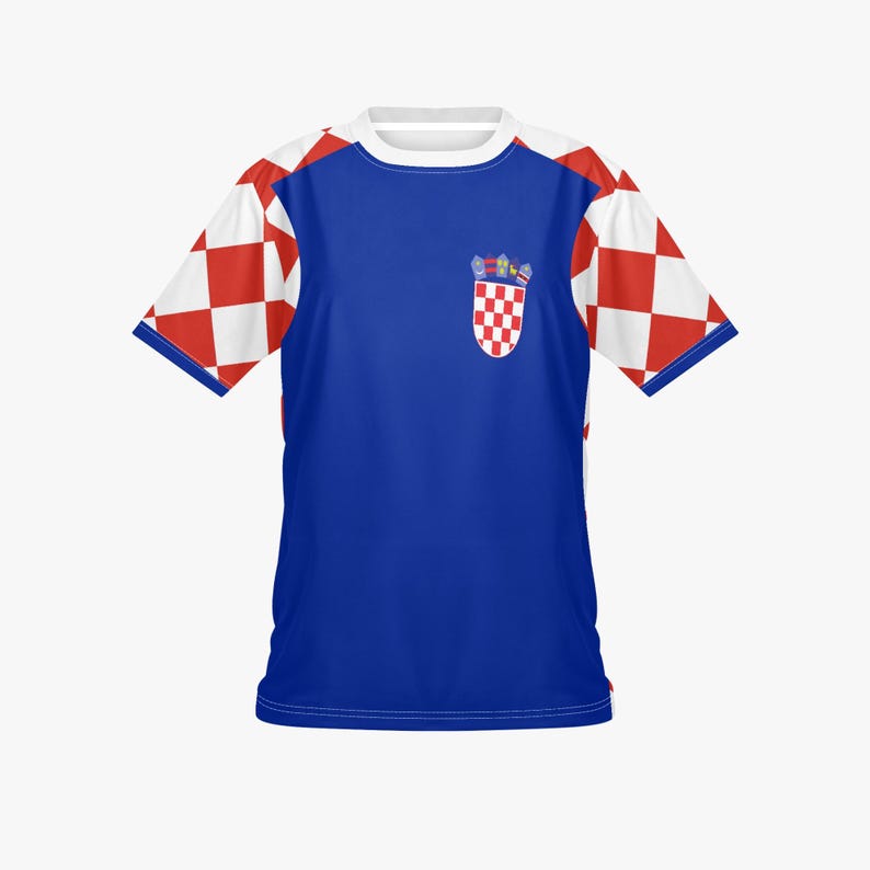 May include: A blue t-shirt with white sleeves featuring a red and white checkered pattern. The shirt has a white collar and a Croatian coat of arms emblem on the chest.