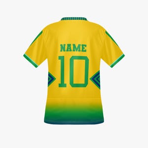 May include: A yellow soccer jersey with green accents, featuring the number 10 and the word "NAME" in green. The jersey has a green and blue design on the sides and collar.