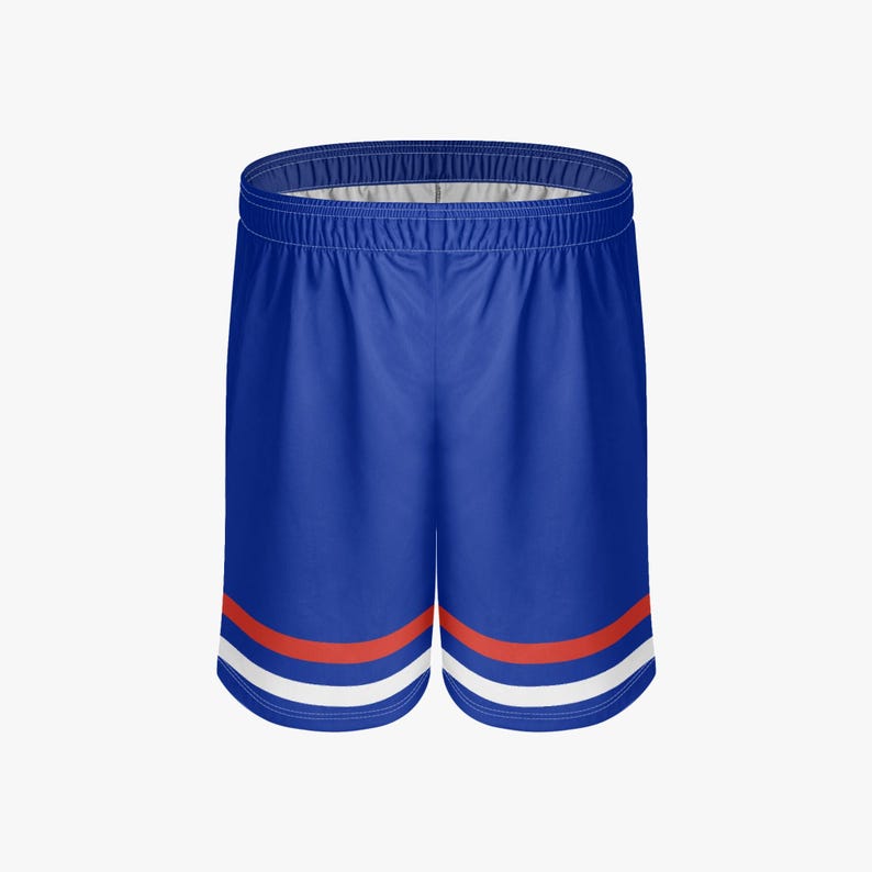 May include: Blue athletic shorts with a white and red stripe design near the hem. The shorts have an elastic waistband and are made of a smooth, likely synthetic material. These shorts are suitable for sports or casual wear.