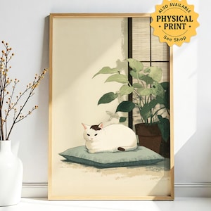 May include: A framed art print featuring a white cat with brown markings, resting on a blue cushion. The cat is in front of a window with plants in a pot. The text "ALSO AVAILABLE PHYSICAL PRINT + See Shop" is in the upper right corner.