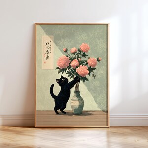 May include: A framed art print featuring a black cat reaching for pink peonies in a vase. The artwork has a vintage aesthetic with a light green floral patterned background and a wooden frame. Japanese text is visible on the left.