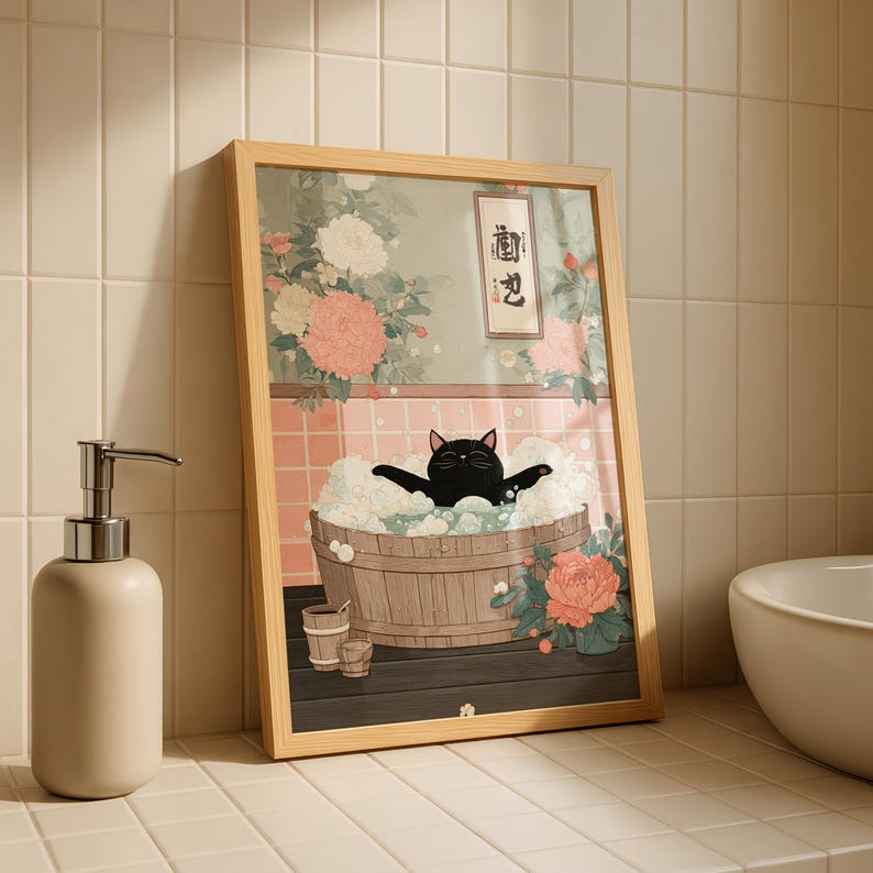 May include: Framed art print featuring a black cat relaxing in a wooden tub filled with bubbles. The artwork has a Japanese aesthetic, with floral and botanical elements in the background. The frame is light wood.