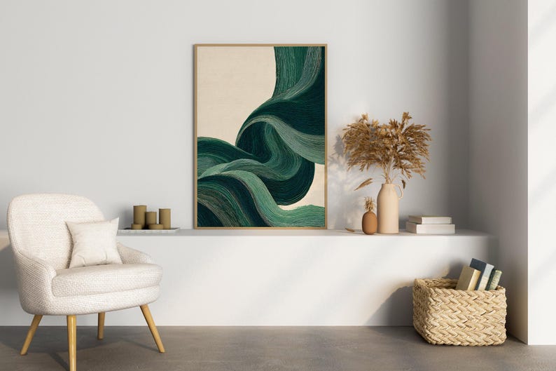 May include: An abstract art print with a wooden frame. The artwork features flowing, layered brushstrokes in shades of green and teal against a beige background. The print is displayed above a white shelf with decorative items.
