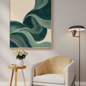 May include: Abstract art print featuring flowing, layered green and teal brushstrokes against a cream background, framed in a light wood. The artwork hangs above a modern armchair with a yellow back and a small side table with a vase of white flowers.