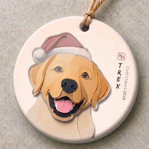 Personalized dog Christmas ornament featuring a golden Labrador named TREX, with a 3.5 mm ceramic base and a 3 mm clear acrylic head-and-Santa-hat layer.