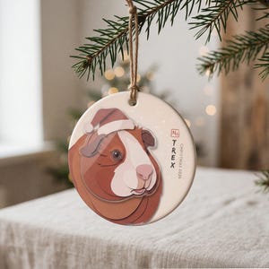 Personalized guinea pig Christmas ornament displayed in a calm, warmly lit holiday setting with the portrait clearly visible.