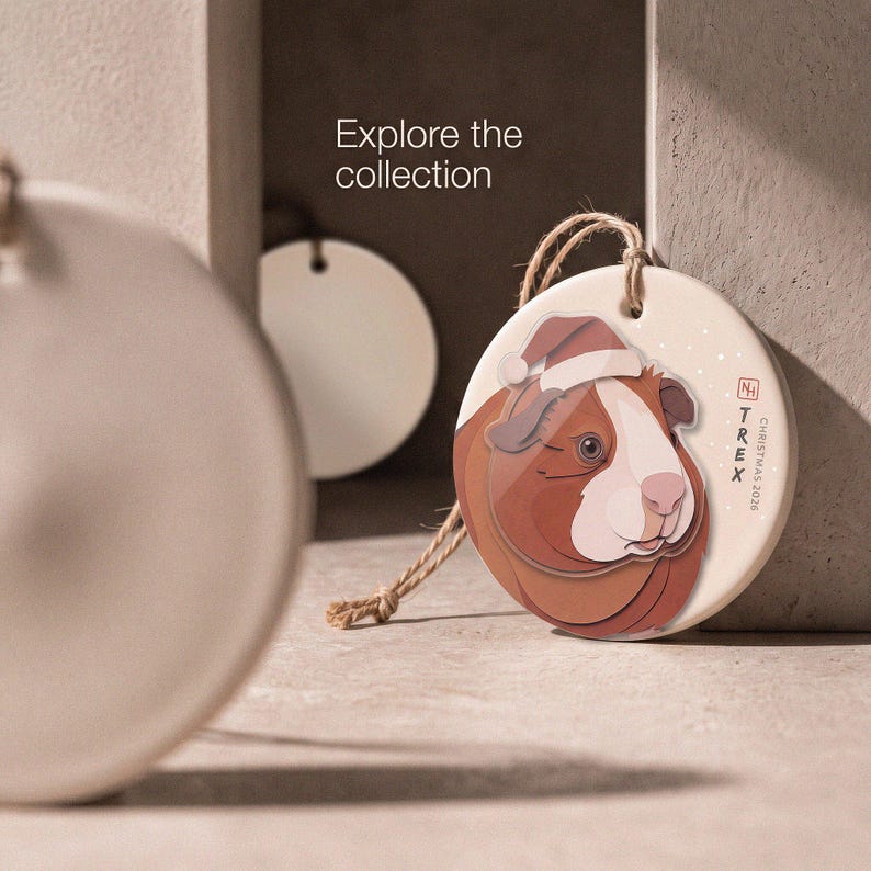 Editorial collection scene with one finished personalized guinea pig ornament and two blank ornaments reserved for future guinea pig series designs.
