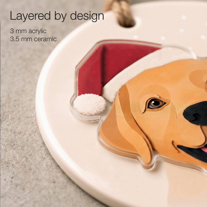 Close-up of the golden Labrador portrait showing printed paper-cut shading, a 3.5 mm matte ceramic base and a 3 mm clear acrylic overlay on the head and Santa hat.