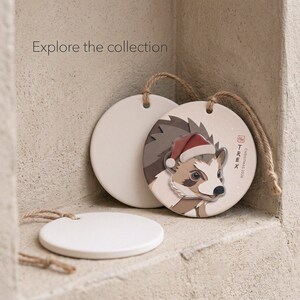 Editorial collection scene with one finished personalized hedgehog ornament and two blank ornaments reserved for future hedgehog series designs.