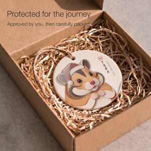 Personalized hamster Christmas ornament protected inside a kraft box with paper filling, ready for careful shipping after design approval.