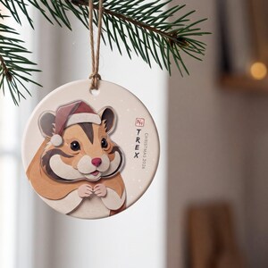 Personalized hamster Christmas ornament displayed in a calm, warmly lit holiday setting with the portrait clearly visible.