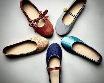 May include: Five pairs of women's shoes in different styles and colors. The shoes include a pair of brown suede flats with a bow, a pair of blue suede flats, a pair of cork flats, a pair of blue leather flats, and a pair of blue patent leather flats.