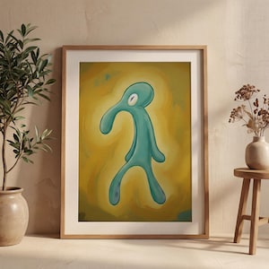 May include: Framed art print featuring a teal-colored cartoon figure with a long nose and one eye, set against a yellow and gold background. The artwork is displayed in a wooden frame, adding a touch of warmth to the piece. The overall theme is whimsical and artistic.