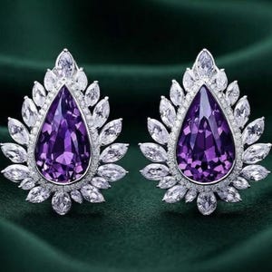 May include: A pair of earrings featuring a large, pear-shaped purple gemstone at the center. The central stone is surrounded by a halo of smaller, clear, marquise-cut stones arranged in a petal-like pattern, set in a bright silver-toned metal.