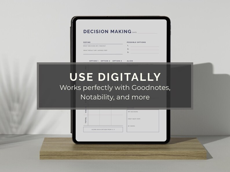 May include: A black tablet displaying a decision-making template, resting on a wooden stand. The screen shows a structured layout with sections for defining decisions and outlining options. A dark gray banner across the screen reads "USE DIGITALLY" and "Works perfectly with Goodnotes, Notability, and more."