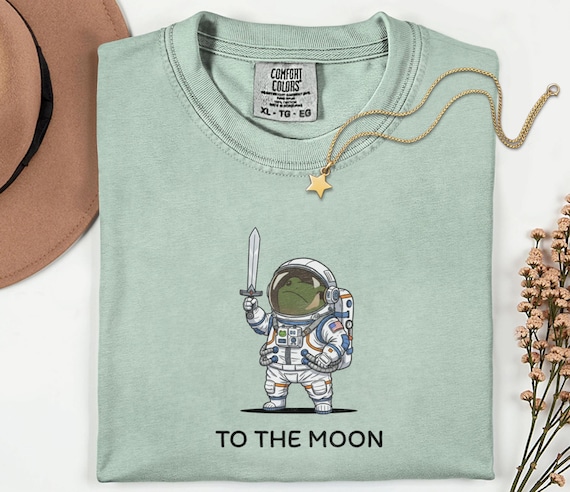 To The Moon Astronaut Frog Graphic Shirt, Funny Space Exploration Tee, NASA Artemis 2 Moon 2026 Humor Gift For Astronomy And Animal Lover