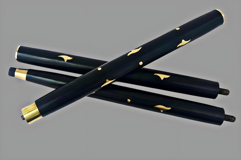 May include: Three black walking cane sections with gold-colored accents. The sections are cylindrical and feature gold leaf-like designs. The ends are capped with gold and have screw threads. The canes are arranged diagonally against a gray background.