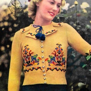 May include: A yellow long-sleeved cardigan featuring a collar with dark blue pom-poms, a button-down front, and colorful floral embroidery on the chest. The garment includes a zigzag pattern on the cuffs and collar, with the text No 49 SPECIAL.