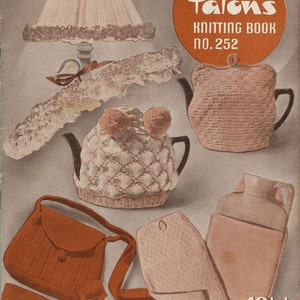 May include: A vintage Patons Knitting Book no. 252 cover featuring illustrations of a lamp shade, a lacy garment, two different knitted tea cozies, a brown shoulder bag, and a hot water bottle cover with the text 10 1/2d. printed on the front.