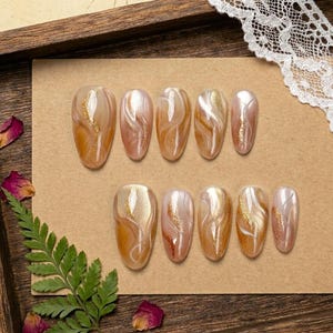 Warm Gold Brown Swirl Long Oval Press On Nail with Shimmer Glitter and Marble Wave Patterns, Fake Nail for Sophisticated Daily Looks