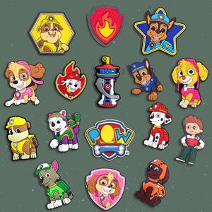 May include: A collection of colorful Paw Patrol character charms. The charms feature various characters in different poses and outfits, including Marshall, Chase, Skye, and Rubble. The charms are in various shapes, including stars, shields, and the Paw Patrol logo.