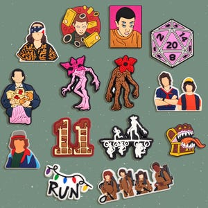 May include: A collection of colorful shoe charms featuring characters and symbols from the popular science fiction series. The charms include character portraits, a dice, and the word "RUN" in lights.