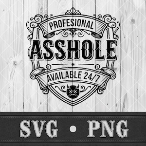 May include: Black and white graphic design with the text "PROFESIONAL ASSHOLE AVAILABLE 24/7" in a decorative shield shape. Below the shield are the letters "SVG • PNG" on a black background. The background is a light wood texture.