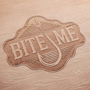 May include: Wooden sign with the words "BITE ME" and a fishing hook design. The sign is light brown with a decorative border and is set against a wood grain background. The sign is likely for a fishing enthusiast.