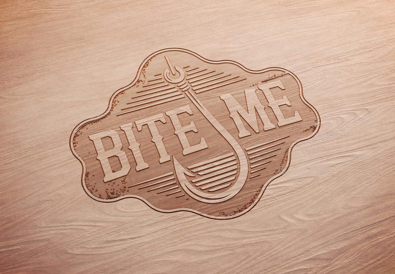 May include: Wooden sign with the words "BITE ME" and a fishing hook design. The sign is light brown with a decorative border and is set against a wood grain background. The sign is likely for a fishing enthusiast.