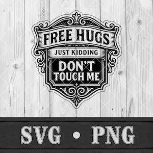 May include: Black and white graphic design with the text "FREE HUGS JUST KIDDING DON'T TOUCH ME" in a decorative frame. The design is set against a light wood background, with "SVG • PNG" at the bottom.