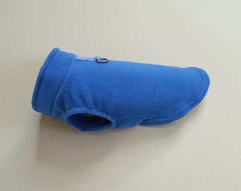 May include: A vibrant blue fleece dog coat. The coat features a collar, a zipper closure, and a small opening for the dog's legs. The coat is designed to provide warmth and comfort for small dogs during colder weather.