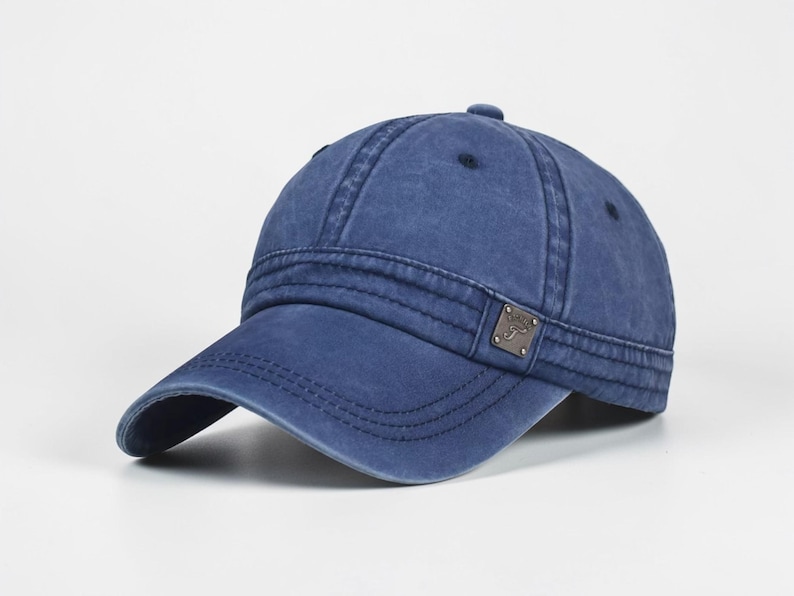 Puede incluir: Gorra de b&eacute;isbol azul con visera curva. La gorra tiene un aspecto desgastado, con costuras visibles y un peque&ntilde;o emblema met&aacute;lico en el lateral. La gorra est&aacute; hecha de un material suave y tiene un estilo cl&aacute;sico e informal.