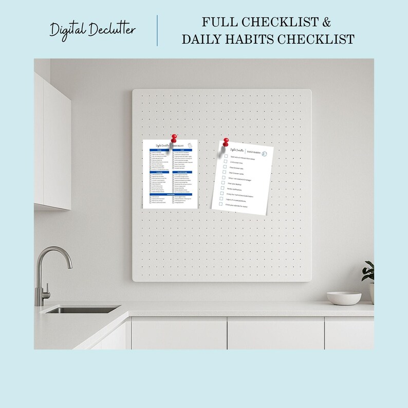 May include: A white pegboard with two sheets of paper pinned to it. One sheet is a full checklist with blue headings and text. The other is a daily habits checklist. The text "Digital Declutter" and "FULL CHECKLIST & DAILY HABITS CHECKLIST" are visible.