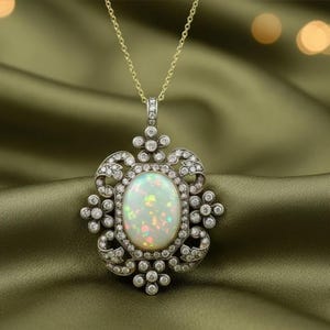 May include: A gold necklace with an elaborate pendant. The pendant showcases a large, oval opal gemstone, encircled by a detailed silver setting with many small, sparkling clear gemstones. The necklace is suspended from a fine gold chain.