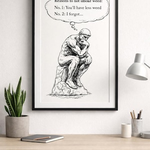 May include: Black and white framed print featuring a sketch of a seated man in thought. Above the man is a thought bubble with the text "Reasons to not smoke weed: No. 1: You'll have less weed No. 2: I forgot..."