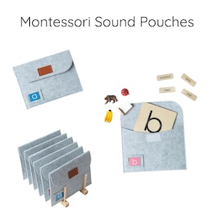 May include: Montessori Sound Pouches. Light gray felt pouches with brown leatherette closures and letter labels. Includes wooden letter cards, miniature objects like a bear and banana, and the text "Montessori Sound Pouches".