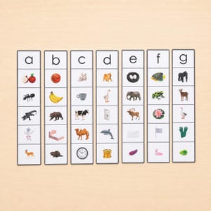 May include: Seven vertical educational cards arranged side-by-side, each headed by a lowercase letter from a to g. Each card contains five small, distinct color illustrations of objects, animals, or food items corresponding to the starting letter.