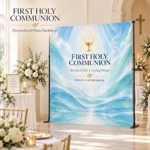 May include: A First Holy Communion photo backdrop featuring a blue and white abstract wave design, a golden chalice icon, and the text "FIRST HOLY COMMUNION Bread of Life • Living Water GRACE CATHEDRAL" printed on a large fabric display stand.