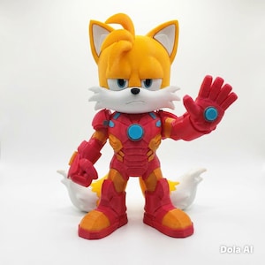May include: A figurine of Tails from Sonic the Hedgehog, wearing an Iron Man suit. The figure is primarily red and gold, with blue accents. Tails has yellow fur, white muzzle, and blue eyes. The figure is standing with one hand raised.