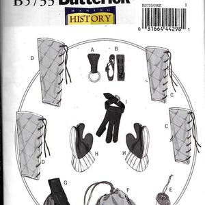 May include: A sewing pattern for a historical costume, featuring a set of leather gauntlets, a pouch, a bag, and a pair of leggings. The pattern is labeled "B5733 Butterick Making History".