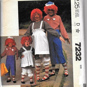 May include: A sewing pattern for four rag doll costumes. The pattern is for sizes 4-14 and includes instructions for making a boy and girl rag doll costume. The pattern is from McCall's and the pattern number is 7232.