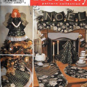 May include: A Simplicity Holiday pattern collection with Christmas-themed crafts. The image displays a doll, tree skirt, table runner, and other decorative items with plaid and floral patterns. The word "NOEL" is displayed on pillows.