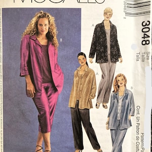 May include: A sewing pattern for a women's jacket and pants set. The pattern is McCall's 3048 and includes three different styles. The first style is a pink jacket and pants set, the second is a brown jacket and pants set, and the third is a blue jacket and pants set.